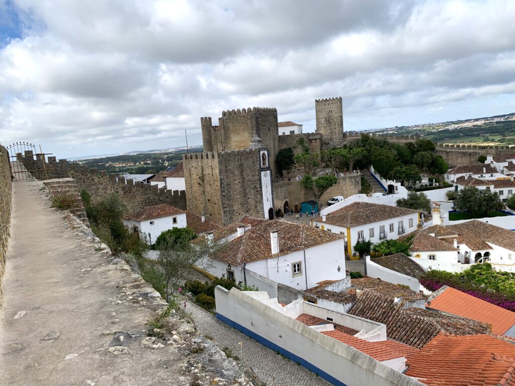 View of Obidos Castle and part of the from above the stone wall that encircles the town.