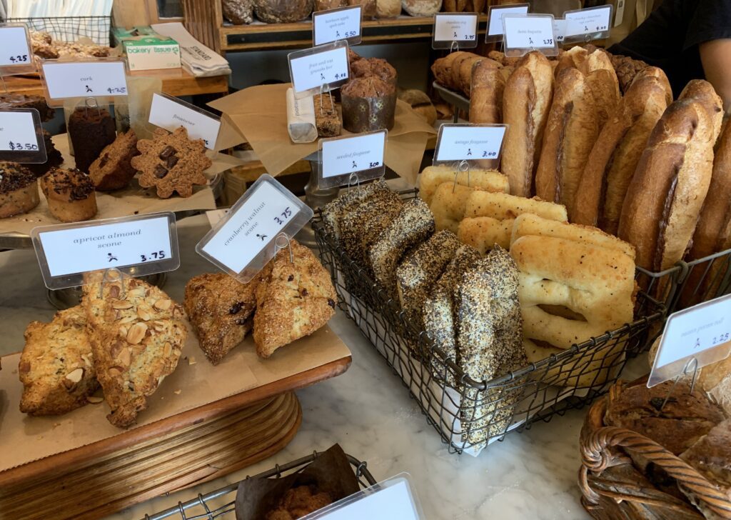 A selection of breads and pastries in baskets.