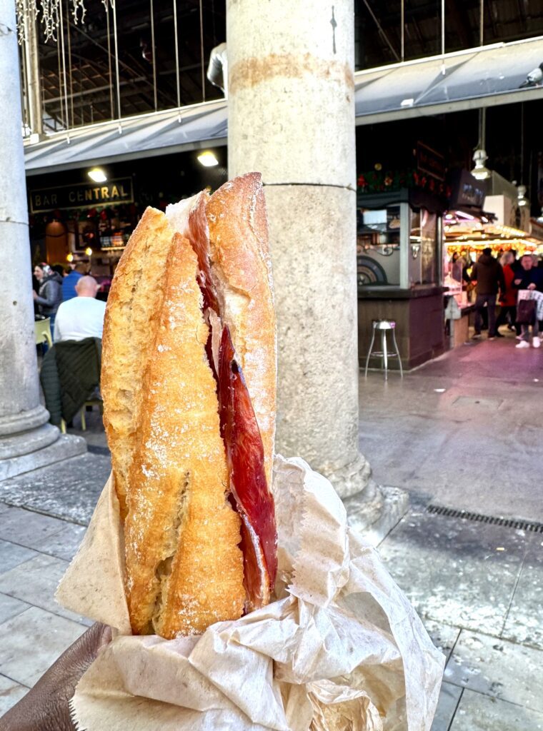 A crusty baguette with an Iberico Jamon filling from Boqueria Mercat, Barcelona, Spain.